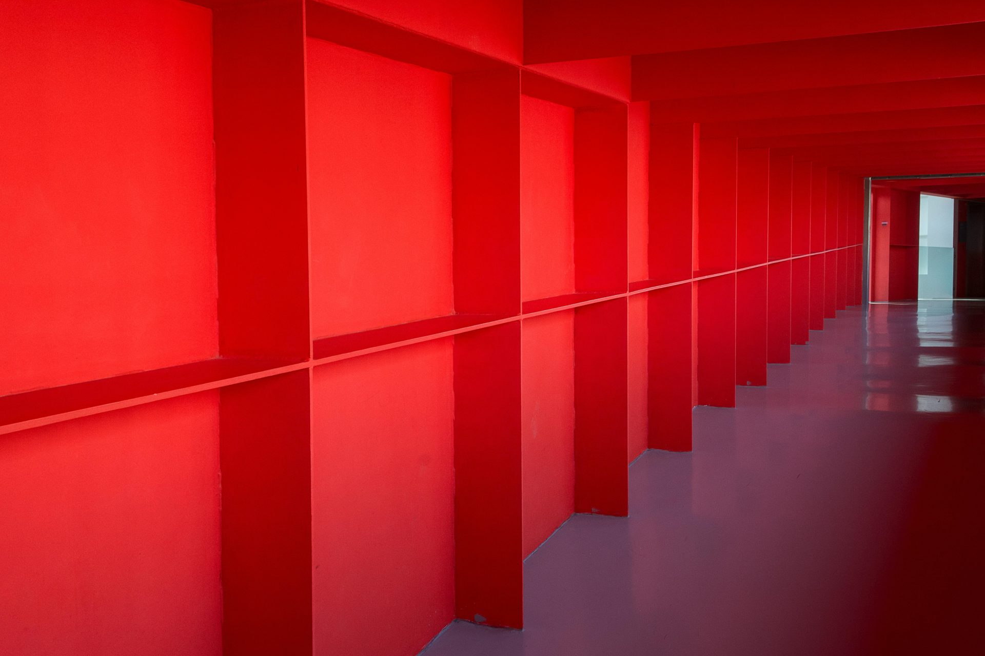 A red hallway with a red wall and a red door